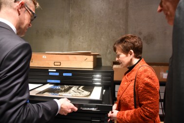 An image of Director Simon Rees shows Dame Patsy Len Lye paper works