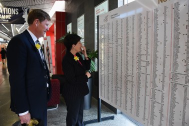 An image of Dame Patsy and Mike Stanley looking at the honour board of NZ Olympic athletes