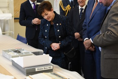 Image of Dame Patsy looking at papers from the Sir Peter Blake archive
