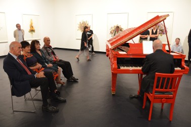 Image of Micahael Houston playing the Michael Parekowhai piano sculpture