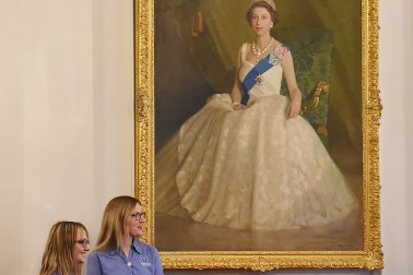 Image of the Queen's Guide award presentation in front of the portrait of the Queen