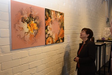 Image of Dame Patsy examining Kathryn Wightman's stunning powdered glass work