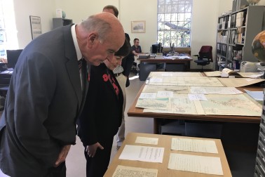 an image of Dame Patsy and Sir David inspecting early letters and maps of New Zealand