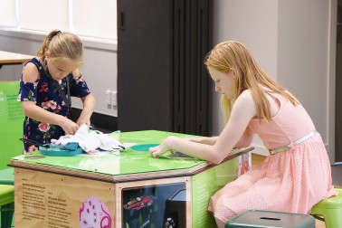 Image of Isabelle and Amelia Bowen trying out some of the features in the Education Centre 