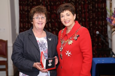 Image of Mary Butler accepting a QSM on behalf of The late Mr Rod Eatwell 