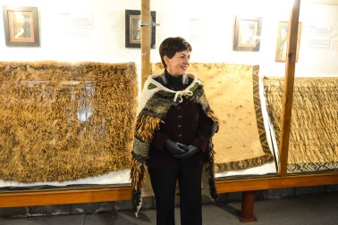 Dame Patsy with some of Okains Bay Museum's beautiful korowai