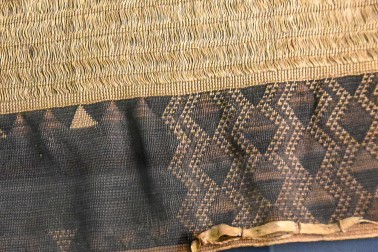 Detail of a large, very finely woven cloak, featuring dog-skin trim