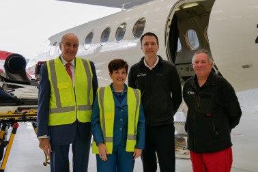 Dame Patsy Reddy and Sir David Gascoigne with the Life Flight air ambulance