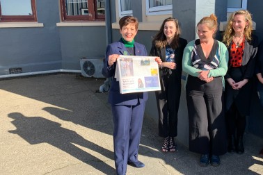 Image of Dame Patsy holding the Westport News
