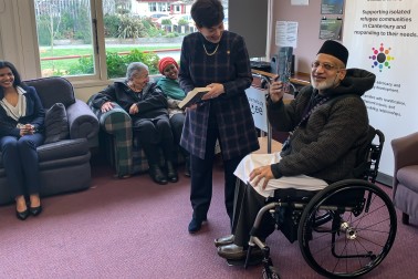 Image of Farid Ahmed gifts Dame Patsy a copy of his book