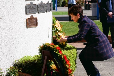 Dame Patsy laying a wreath on the Memorial Wall