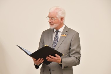 Image of Official Secretary Greg Baughen reading Sr Catherine Hannan's citation