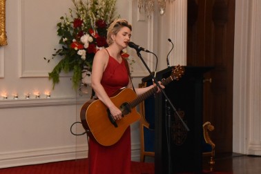 Julia Deans singing and playing guitar