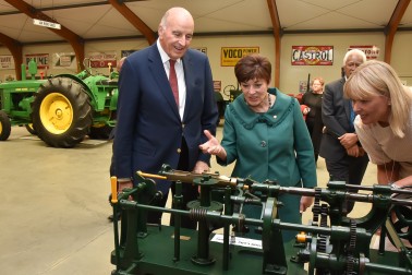 Jocelyn O'Donnell demonstrating a lolly wrapping machine to Their Excellencies