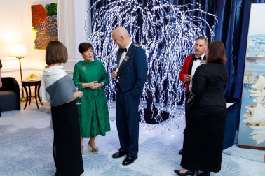 Dame Patsy Reddy with guests by a light up tree