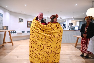 Dr Davies and Dame Cindy were wrapped in a traditional Cook Islands quilt presented to them by the Consular Corps