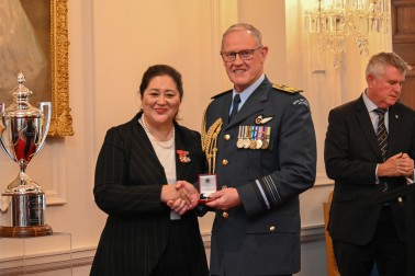 Dame Cindy presenting a medal to Air Marshal Kevin Short, Chief of Defence Force