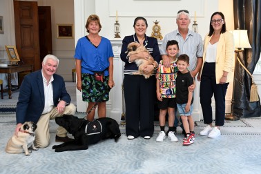 Official photo with Their Excellencies, Pebbles, Lucy, the Walkinshaw family and Kiro the guide dog in training