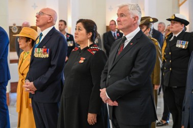 Their Excellencies stand in reflection during the Last Post