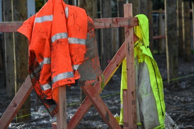Muddy construction jackets on the site of one of the total rebuilds