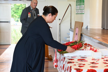 Dame Cindy lays a wreath