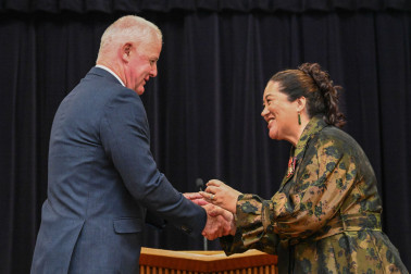 College Principal Gary Moore presents Dame Cindy with her lapel pin