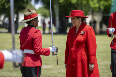 Dame Cindy speaking to a graduating officer cadet