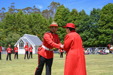 Dame Cindy congratulating a graduating officer cadet