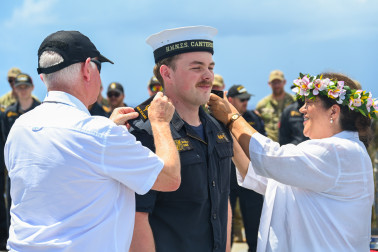 Their Excellencies presenting a member of the ship's company with his new insignia