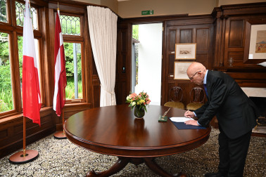 Ambassador Borg-Marks signing the visitors book.