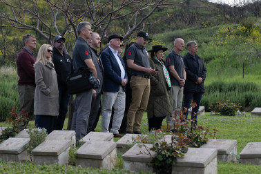 Dame Cindy, Dr Davies and the official party sing a waiata at the No. 2 Outpost Cemetery
