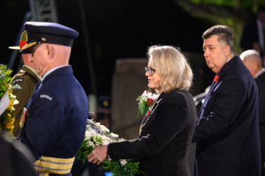 Dame Helen carries her wreath to be placed