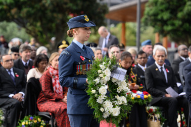An RNZAF representative bears Dame Helen's wreath