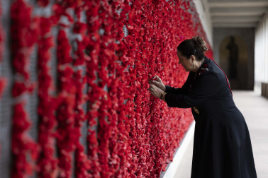 Dame Cindy places a poppy at the Roll of Honour 