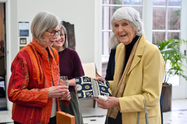 Guild members admire examples of embroidery