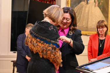 Dame Cindy places a korowai around outgoing Board Chair Sarah Tocker