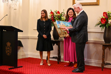 Incoming Board Chair Venus Guy presents Their Excellencies with two artworks created by kindergarten children