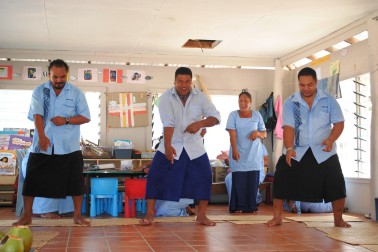 Teaching staff perform a song/dance for the Governor-General.
