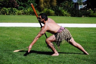 A member of the New Zealand Defence Force Cultural Group offers a dart to the manuhiri.