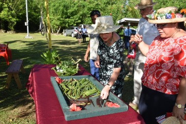 The Governor-General, the Rt Hon Dame Patsy Reddy, looking at vanilla beans grown on the farm.