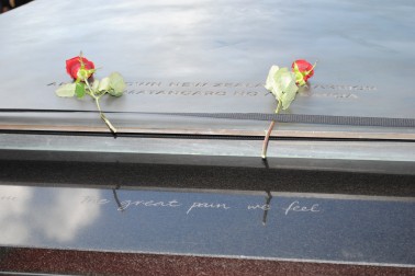 Sir Jerry and Lady Janine Mateparae each place a rose on the Tomb of the Unknown Warrior.