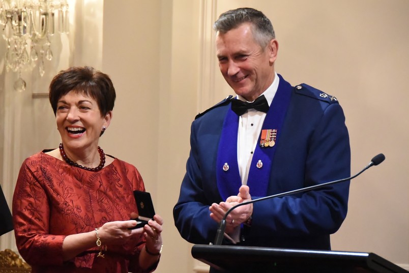 an image of Police Commissioner Mike Bush presenting Dame Patsy with the medal