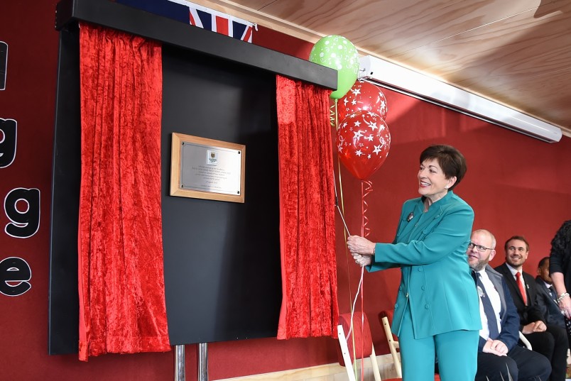 an image of Dame Patsy unveiling a plaque to mark the official opening 
