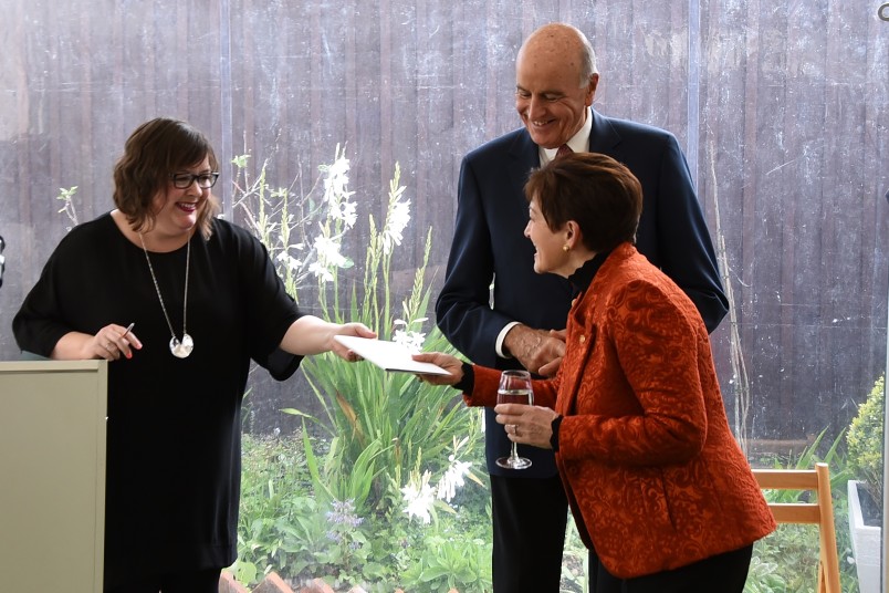 Image of Dame Patsy being presented with a copy of Te Whare Tāre, the first Te Reo translation of The Dolls House - 
