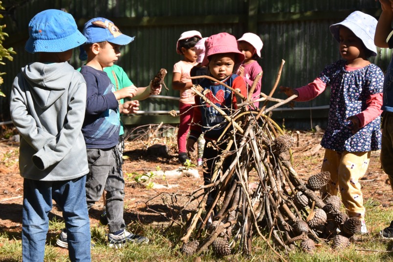 children assembling a wooden structure