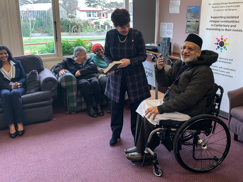 Image of Farid Ahmed gifts Dame Patsy a copy of his book