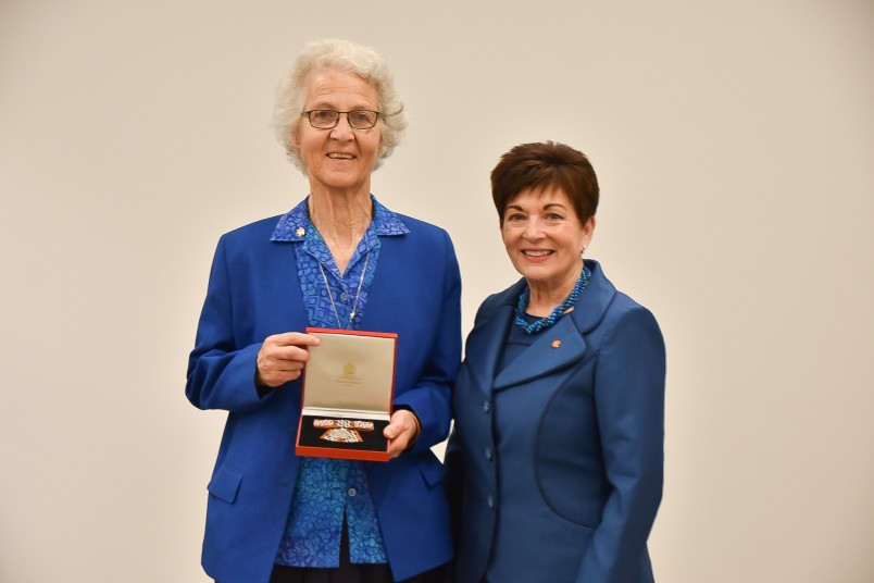 Image of Sr Margaret Anne accepting Sr Catherine's QSM for the Sisters of Compassion archives