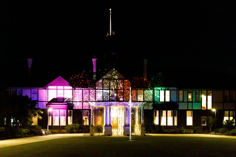 Government House lit up with a projection of fireworks