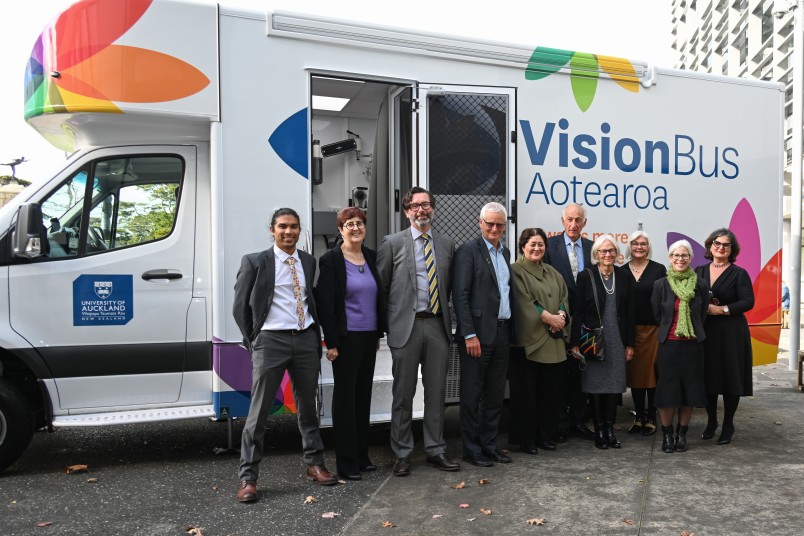 People who make Vision Bus Aotearoa possible gather outside the bus