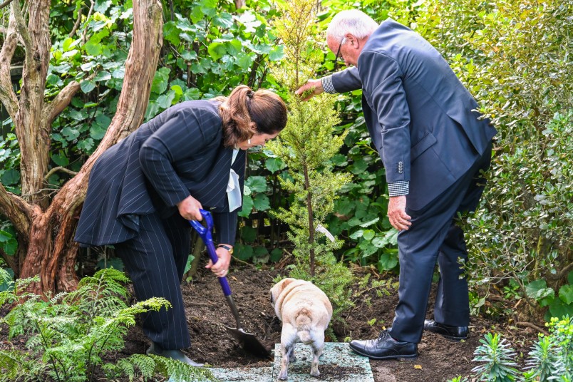 Dame Cindy and Joris De Bres of Project Crimson planting the tree, ably assisted by Their Excellencies' pug Pebbles